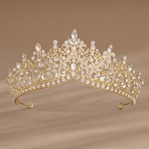 Detailed close-up of luxury gold bridal crown featuring intricate baroque metalwork and crystals