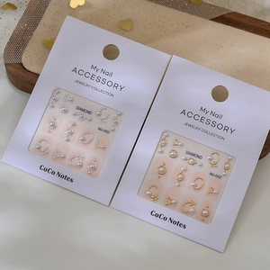 3D nail art accessory set with adhesive pearls and gold metal shapes on white cards