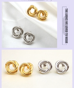 Detail of twisted triple hoop earrings in polished gold and silver metal finishes