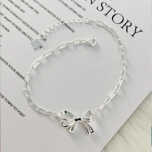 Elegant S925 sterling silver bow knot bracelet with hollow chain links on white background