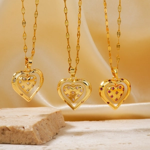 Elegant gold heart necklaces with white, purple, and red crystals on yellow satin background