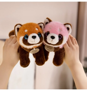 Pair of plush orange and pink raccoons with glittering eyes and soft textures