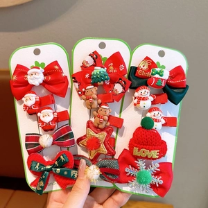 Detailed view of Christmas hair clip set with snowman and star patterns on a card