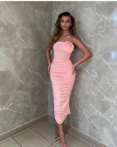 Detailed close-up of pink strapless dress featuring 3D rose and ruched bodycon design