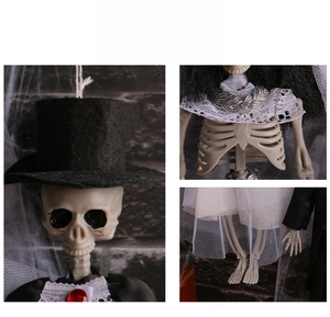 Macro details of Halloween skeleton bride and groom hanging decor showing lace and jewelry