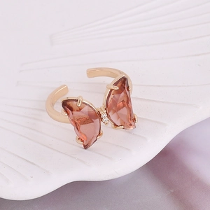 Macro shot of an adjustable gold ring with amber butterfly crystal and zircon details