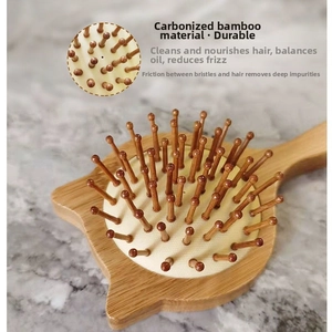 Macro detail of cartoon cat shaped bamboo hair brush with durable carbonized wood bristles