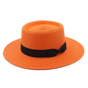 French style orange flat top straw boater hat with black ribbon and wide sun brim