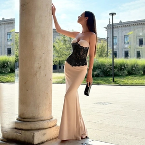 Detail of waist corset featuring black floral lace on a beige slim-fit evening dress