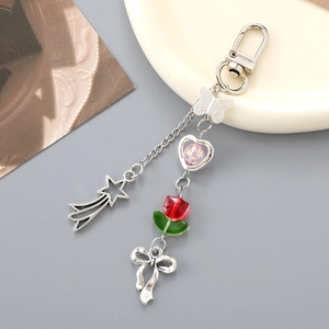 Detail view of Y2K silver metallic keychain featuring stars, hearts and tulips charms