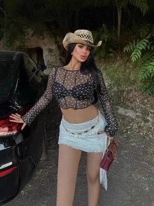 Women's black polka dot sheer mesh crop top with long sleeves for a retro summer style