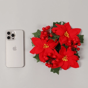 Artificial Christmas candle ring with red poinsettia and berries for table decoration