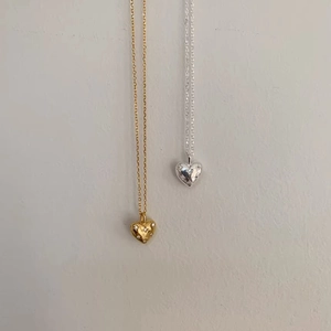 Minimalist heart pendant necklaces in gold and silver with starburst cubic zirconia