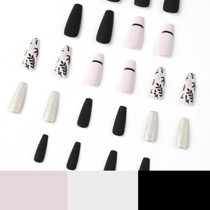 Matte black and pink press-on nails with silver glitter and leaf designs in coffin shape
