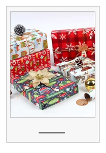 Close-up of festive Christmas wrapping paper with red plaid and vintage holiday prints