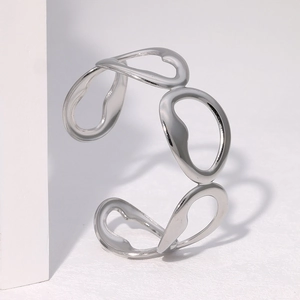 Minimalist silver stainless steel open bangle with irregular hollow link design on white