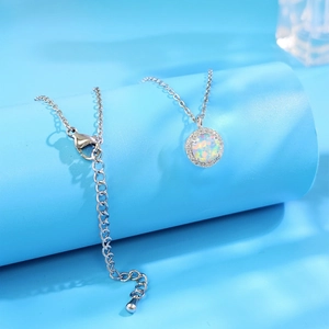Elegant silver halo necklace with 8mm opal stone and adjustable chain on minimalist display
