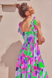 Detail of smocked elastic back and bow-tie straps on colorful floral maxi dress