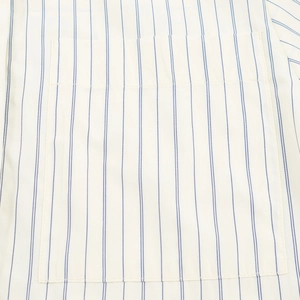 Close-up of chest pocket detailing on a blue and white striped cotton leisure shirt