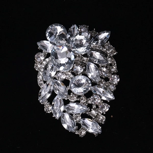 Macro shot of silver alloy brooch with clear marquise and oval cut crystal floral clusters