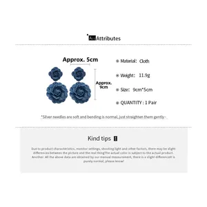 Macro detail of blue denim fabric rose drop earrings with size 9cm by 5cm dimension