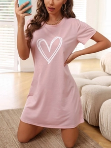 Close-up of pink short sleeve nightgown featuring white heart print on soft cotton fabric
