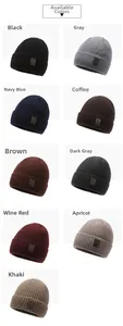 Detail showing the rib-knit texture and rectangular leather patch on various colored beanies