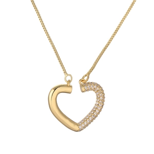 Macro detail of gold plated heart pendant with half polished finish and half micro pave crystals