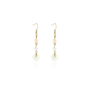 Detail of elegant gold hook earrings with pink beads and a white jade-style ring pendant