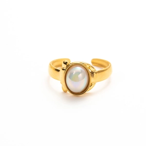 Detail of vintage gold ring featuring a pearl-like oval stone with relief textures