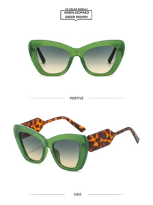 Detail view of cat eye sunglasses featuring green frames and leopard print temples