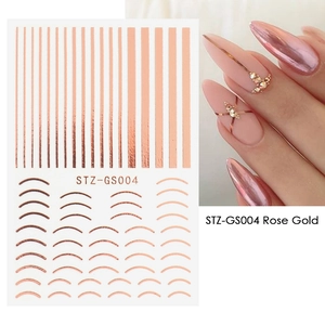 Detail of rose gold metallic nail stickers with stripes and curves on a model hand