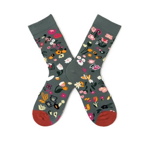 Detail of gray mid-calf socks with floral patterns and contrasting red cuffs and heels