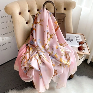 Elegant floral print silk scarf with almond blossom pattern on a soft pink satin fabric
