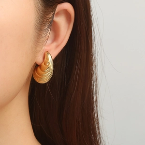 Elegant gold drop hollow earrings with twisted shell texture design for women
