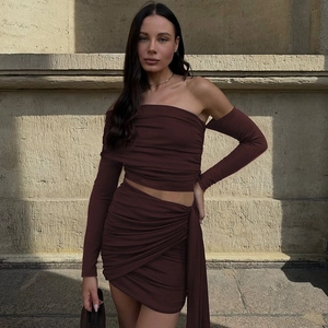 Detail of dark brown ruched off-shoulder top and mini skirt with side tie ribbons