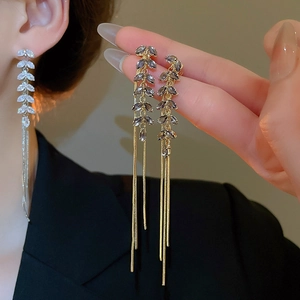 Detailed view of long leaf tassel earrings featuring marquise-cut sparkling cubic zirconia