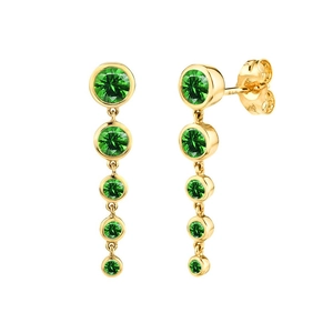 Detail view of gold linear drop earrings featuring five gradient green emerald stones