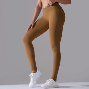 Detail of high-waist yoga leggings with crossover waistband in seamless ginger fabric