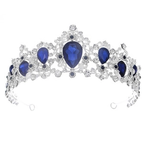 Close-up of luxury silver bridal crown featuring teardrop blue gems and white crystals