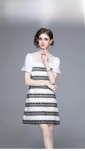 Detail of elegant black and white patchwork dress with beads and tiered lace ruffles