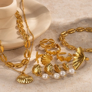 Gold stainless steel jewelry set with pearls featuring shell and ginkgo leaf designs