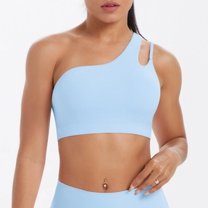 Close-up of light blue one-shoulder sports bra with asymmetric cutout and wide hem band