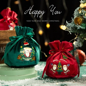 Green and red Christmas velvet drawstring gift bags with festive Santa Claus patterns