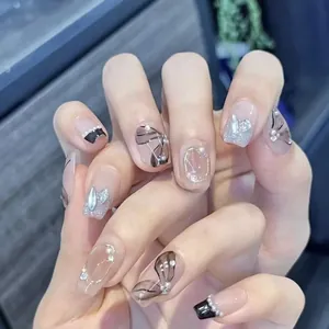 Detail of hand-painted floral nails with pearls and rhinestones in luxury style