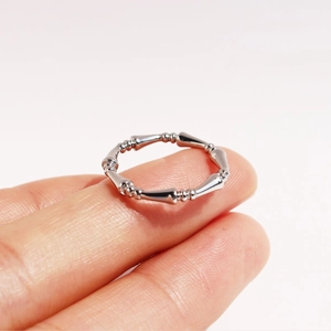 Minimalist silver bamboo joint ring with adjustable band shown on fingers
