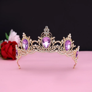 Macro view of gold baroque crown with purple water-drop gems and sparkling crystals