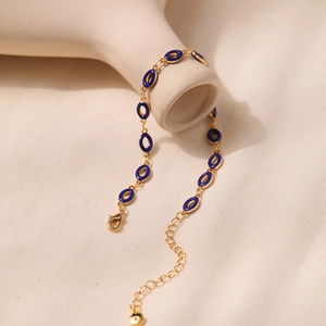 Vintage gold chain bracelet with deep blue enamel oval links and lobster clasp closure