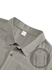 Macro detail of men's linen shirt collar and buttons with textured gray fabric