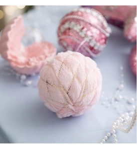 Detail of pink faux fur Christmas ball with gold embroidery for tree decoration